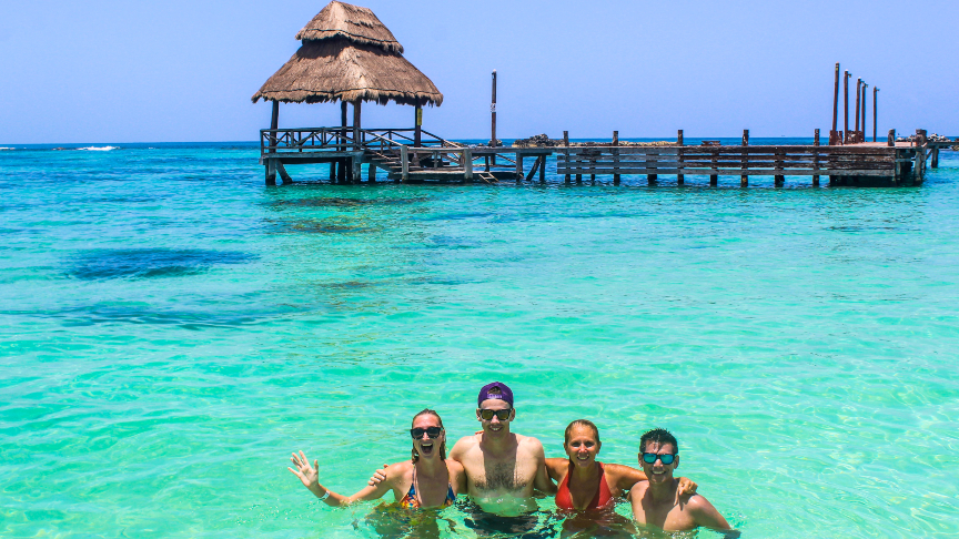 fun with friends at beautiful blue turquoise water at isla mujeres, mexico